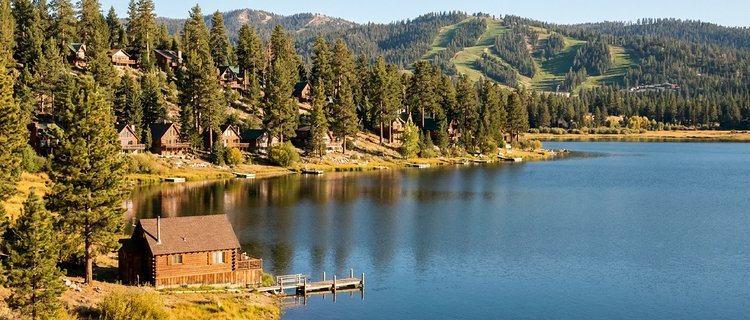 Lakefront Big Bear cabins among the pines with the ski slopes across the water, the lake, lift, and forest settings owners choose between